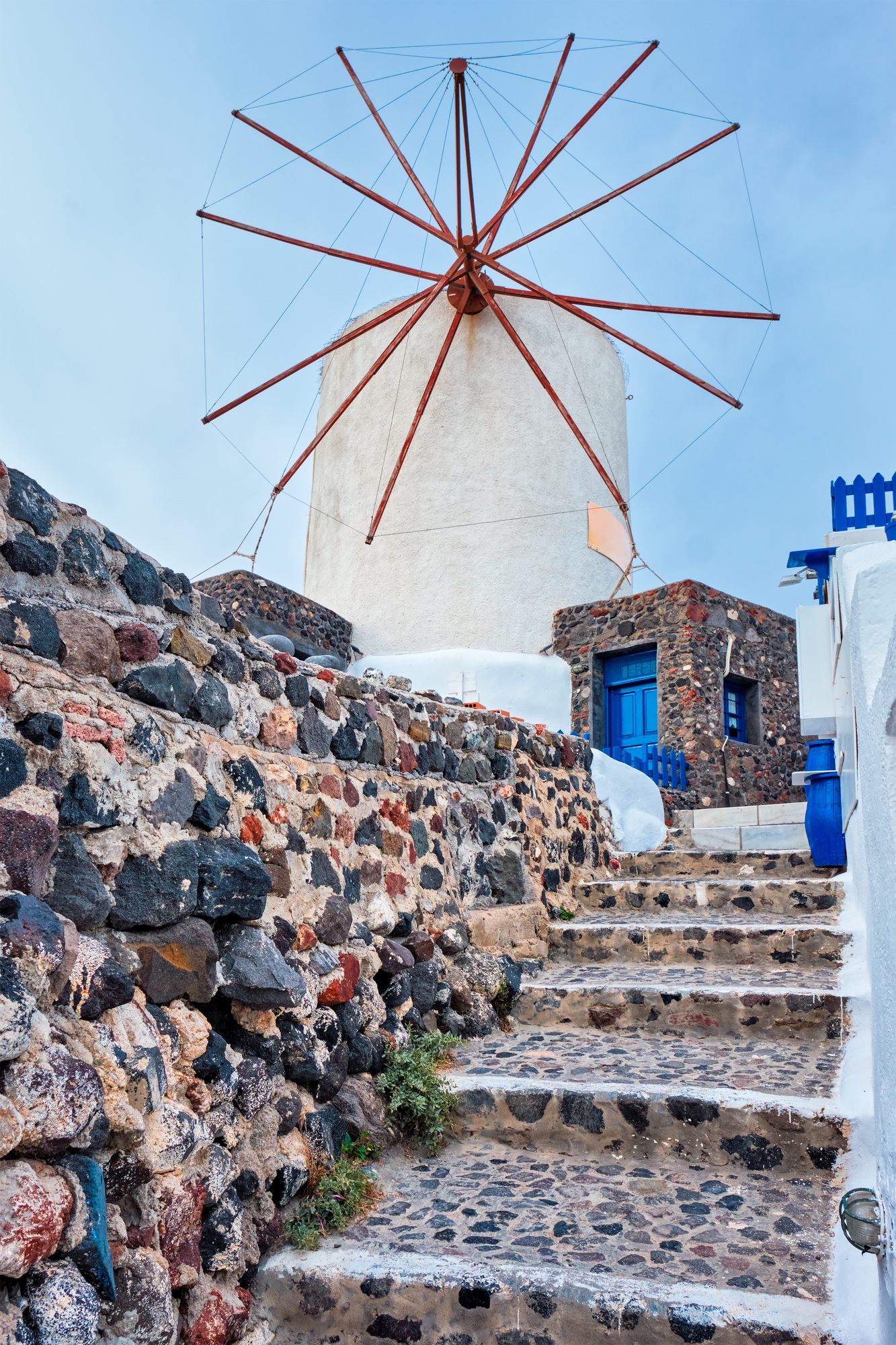 Old greek windmill on Santorini island in Oia town with stairs in street. Santorini, Greece